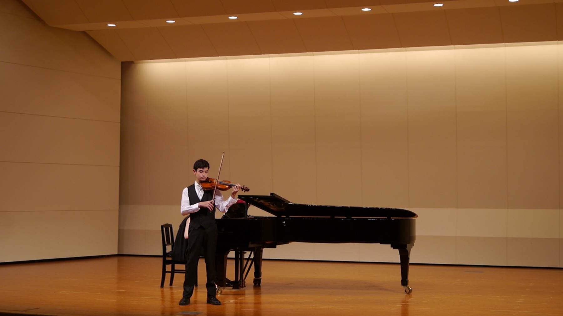 Student performing violin on stage